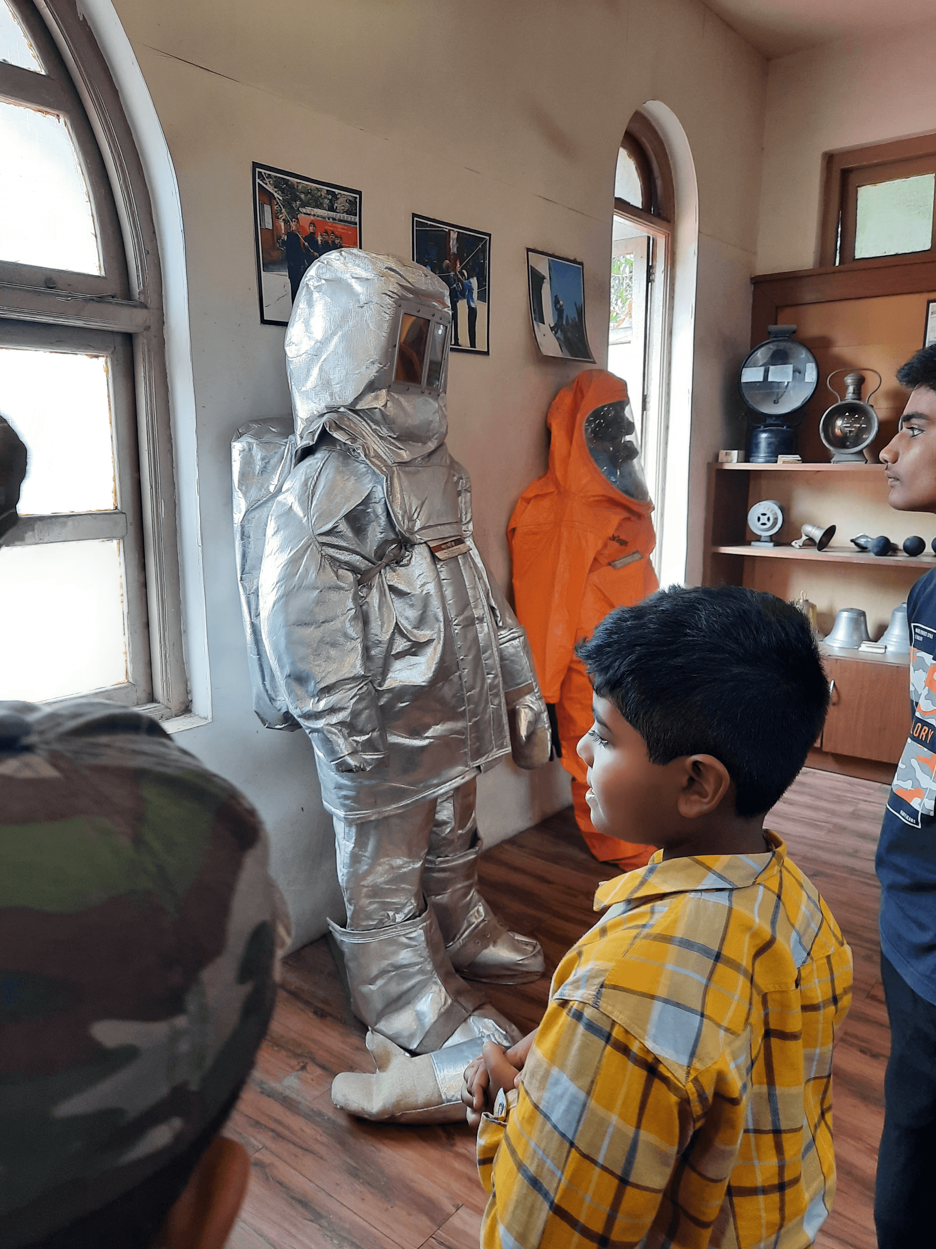 A confident child explaining his technical project to a visiting adult expert