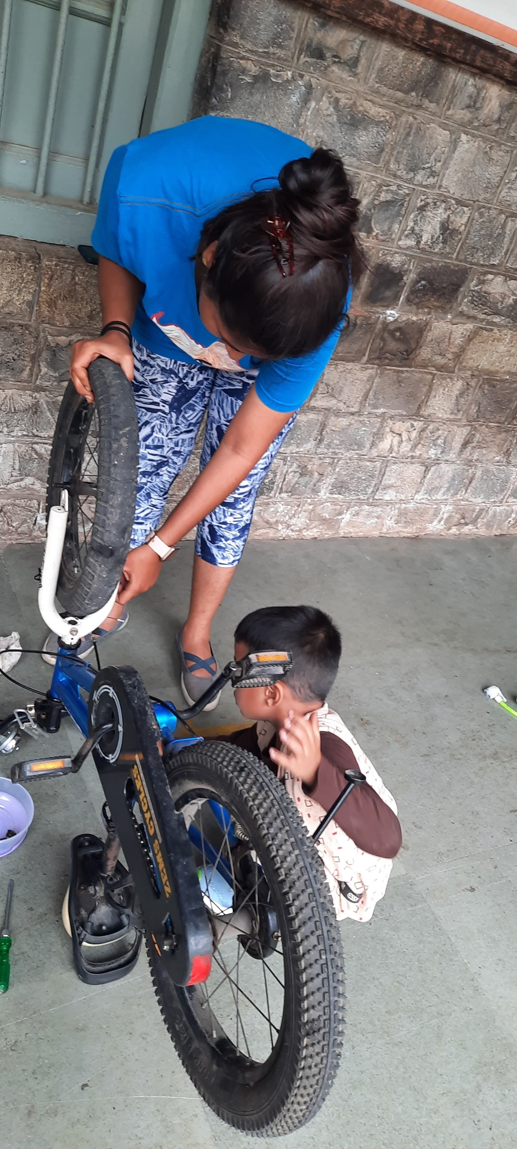 A child carefully exploring and observing a gear system in the lab
